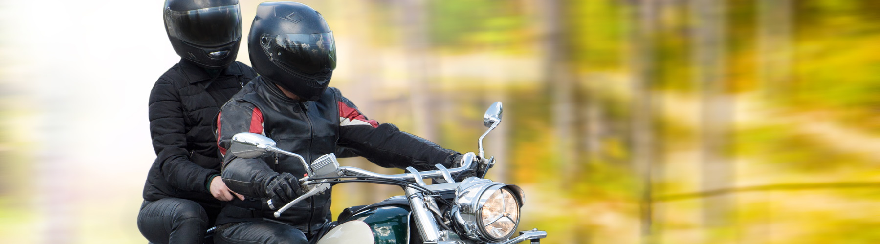 two people riding a motorcycle